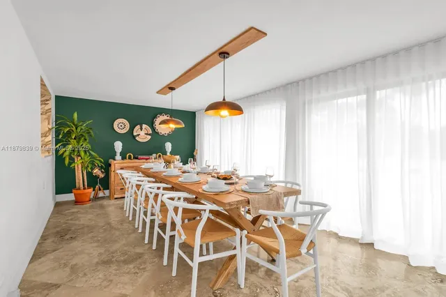 a view of a dining room with furniture and chandelier