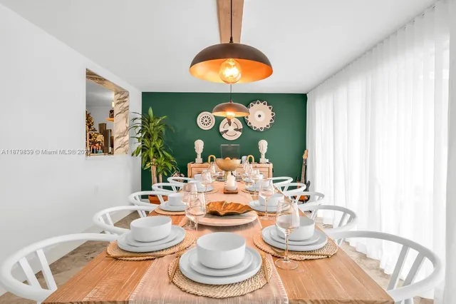 a dining room with furniture and a window