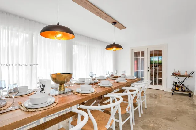 a view of a dining room with furniture wooden floor and chandelier