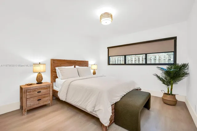 a bedroom with two beds and a window