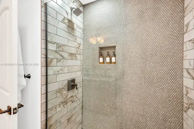a utility room with dryer washer and a view of living area