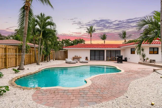 a view of a backyard with sitting area