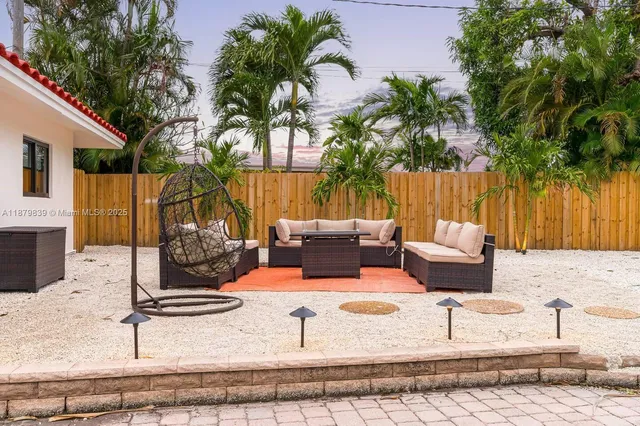 a view of a backyard with a patio and swimming pool