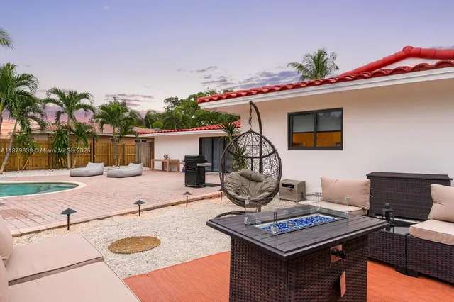 a living room with a couch and a potted plant