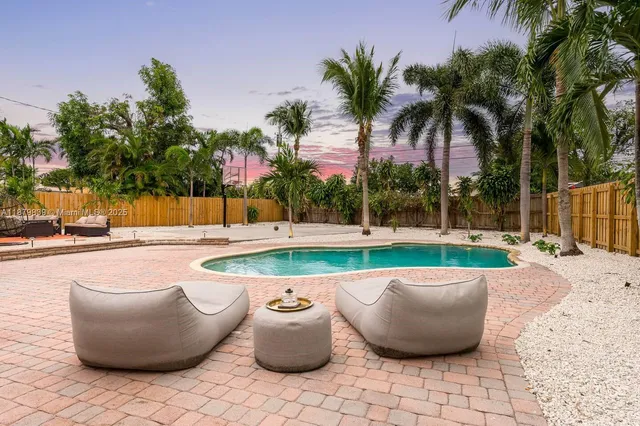 a view of backyard space with palm trees