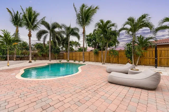 a view of a living room with furniture and a potted plant
