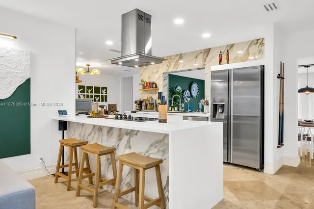 a large kitchen with a table and chairs