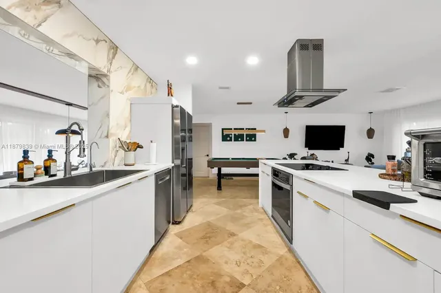 a kitchen with stainless steel appliances a sink stove and refrigerator