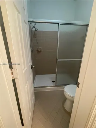 a bathroom with a shower and a toilet