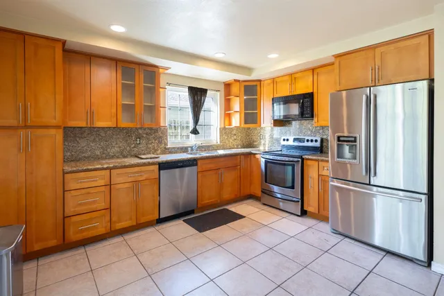 a kitchen with granite countertop a sink and a window