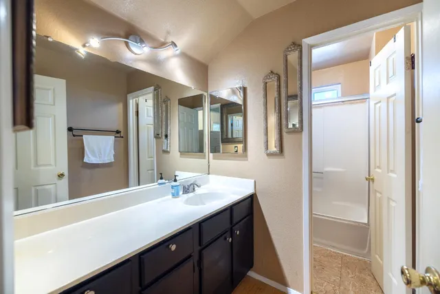 a view of a room with wooden floor and a ceiling fan