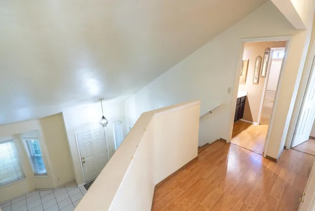 a view of a patio with table and chairs under an umbrella
