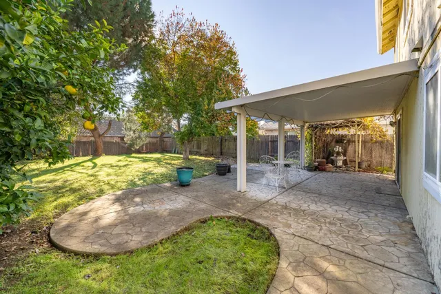 a front view of a house with a yard table and chairs