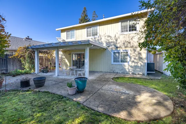 a swimming pool with outdoor seating and yard