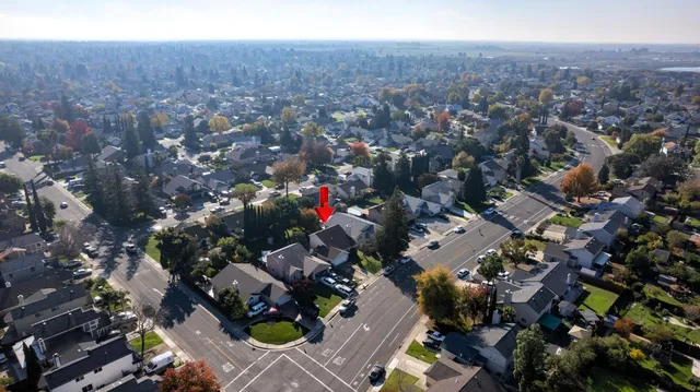 an aerial view of city lake and trees