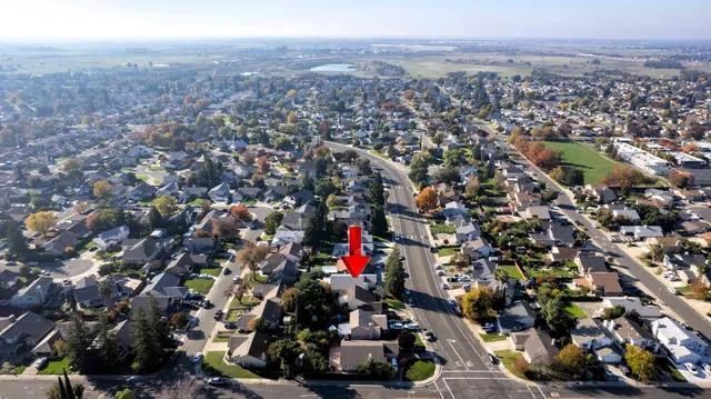 an aerial view of house with backyard