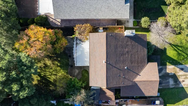 an aerial view of a house with a yard