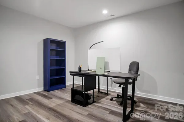 a bedroom with furniture and a wooden floor