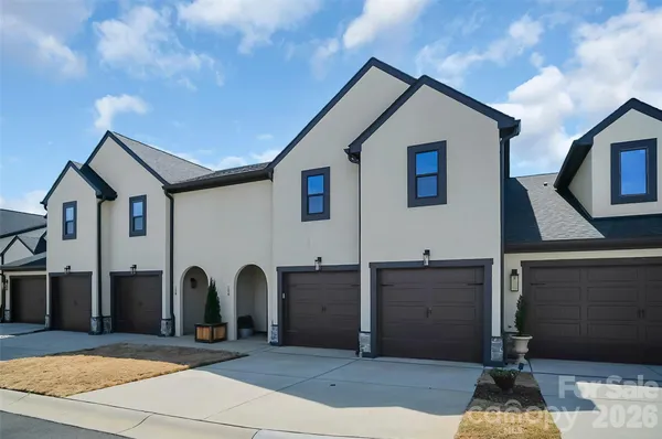 a view of a house with a patio and a yard