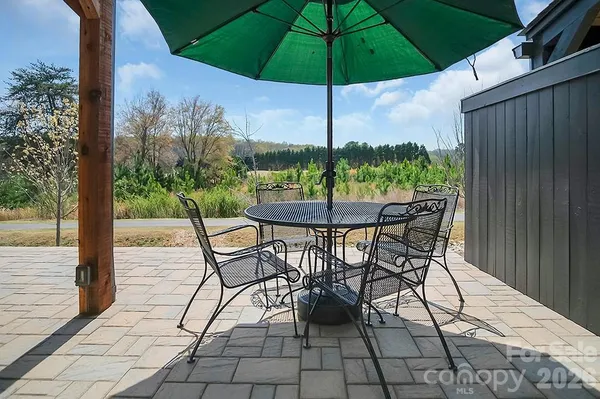 an aerial view of a house with a yard and sitting area