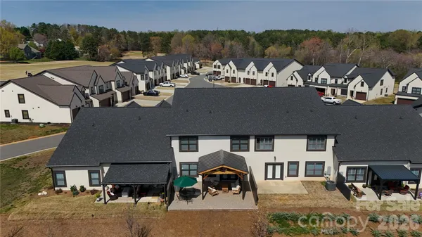 an aerial view of residential houses with outdoor space