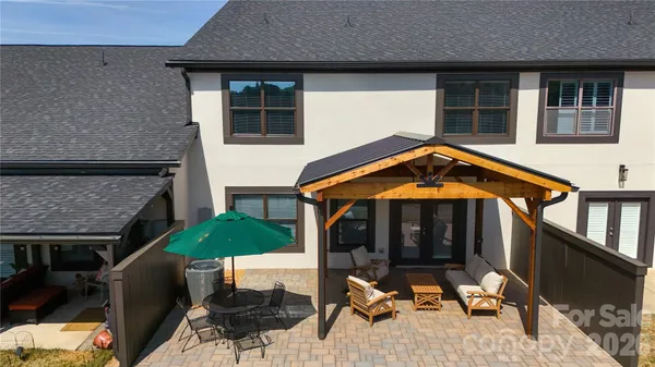 a building outdoor space with patio furniture and wooden floor