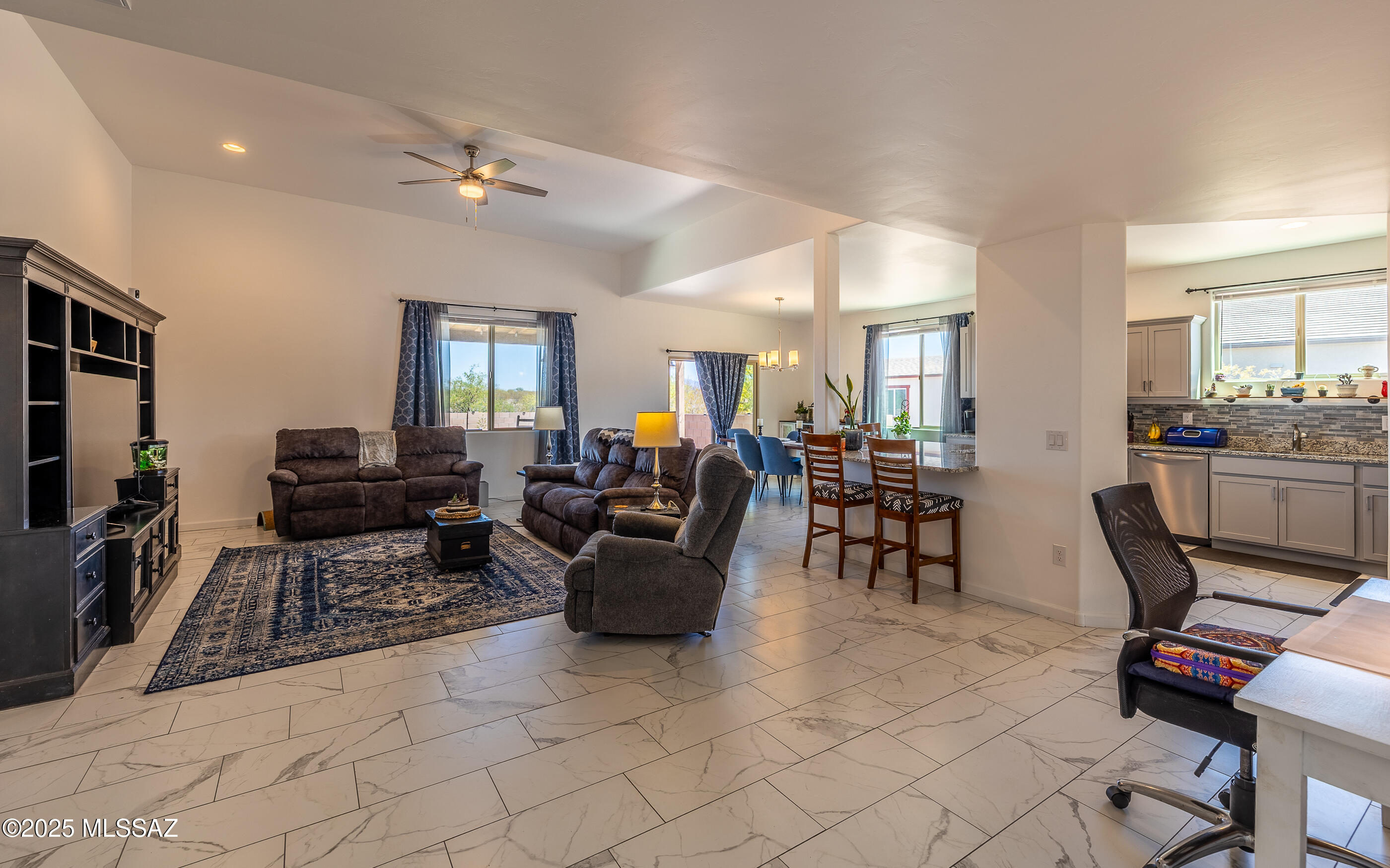 12123 Creosote Valley Road Vail, AZ 85641 - Photo 4 of 46 a living room with furniture and a flat screen tv