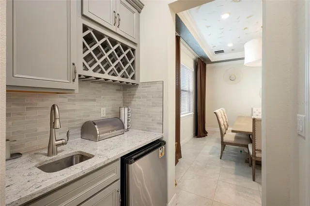 a kitchen with a dining table a stove and a chandelier