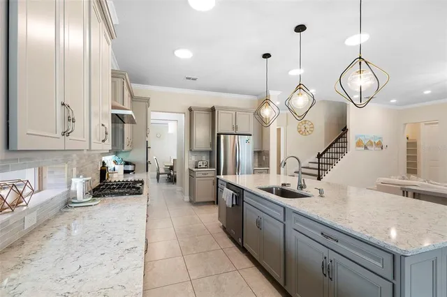 a dining room with furniture a chandelier and window
