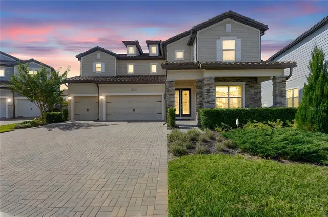 a front view of a house with a yard and garage