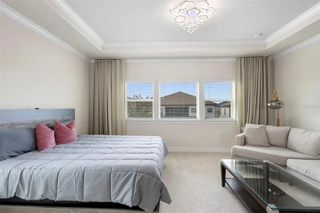 a bedroom with a bed and a chandelier