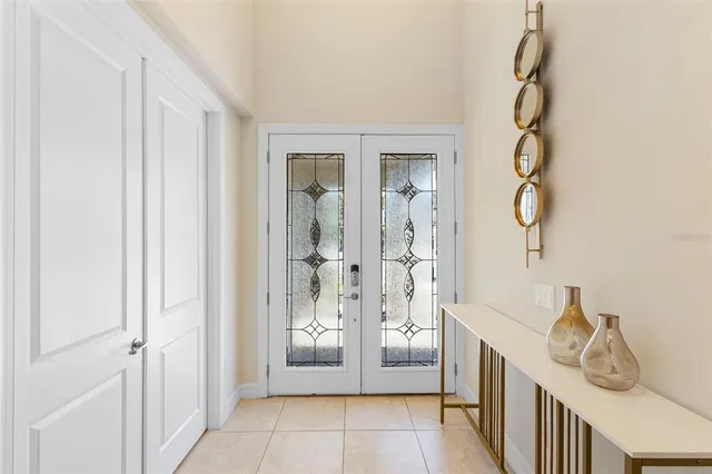 a hallway with a table and a chandelier