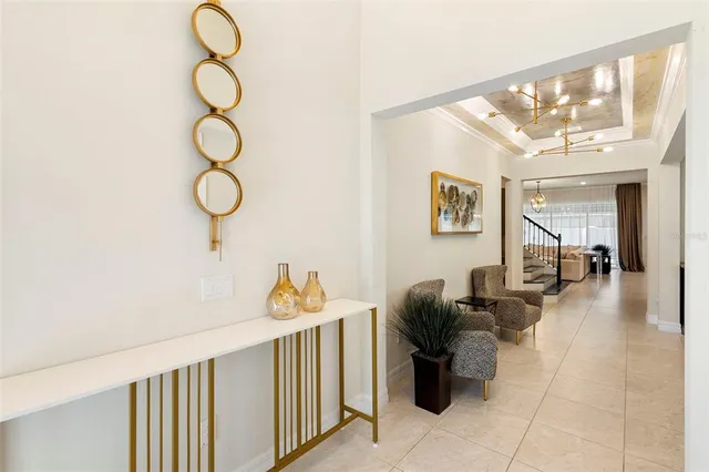 a living room with furniture and a chandelier