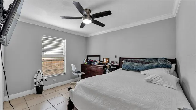 a bed room with a bed and a ceiling fan