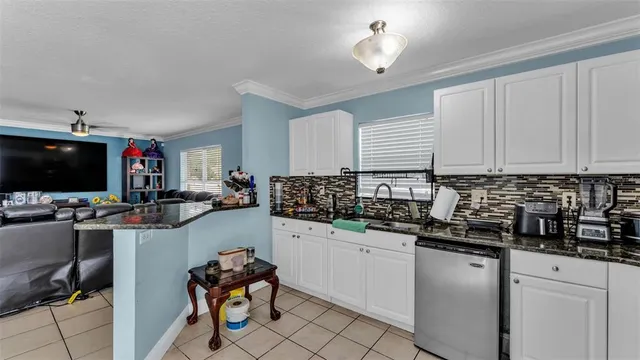 a kitchen with a sink cabinets and window