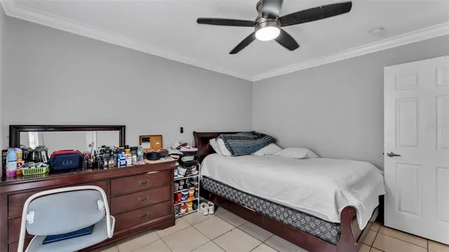 a bedroom with a bed gym equipment and a desk