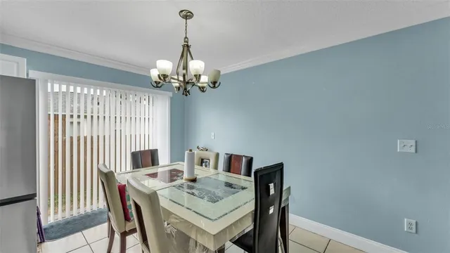 a view of a dining room with furniture and chandelier