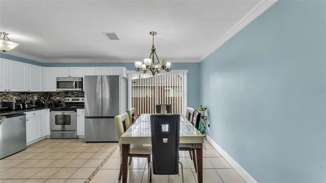 a view of a kitchen with refrigerator and cabinets
