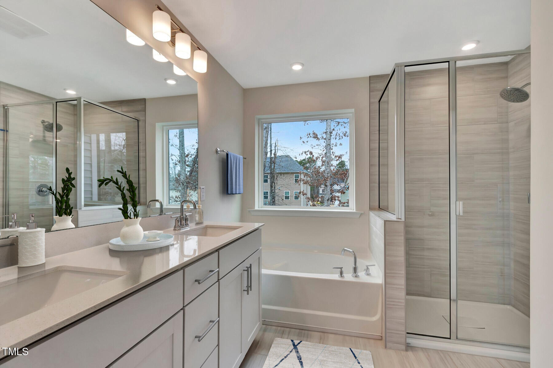7128 Hubner Place, Unit 35 Cary, NC 27519 - Photo 14 of 17 a bathroom with a granite countertop sink a large mirror and a shower