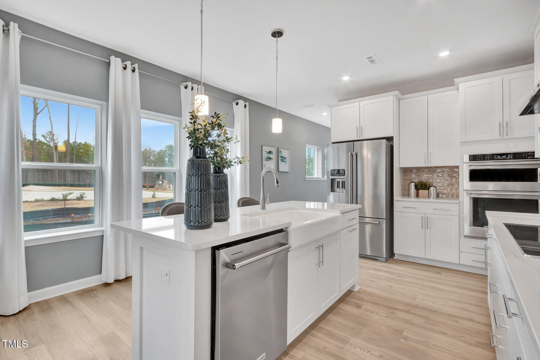 7128 Hubner Place, Unit 35 Cary, NC 27519 - Photo 3 of 17 a kitchen with white cabinets and stainless steel appliances