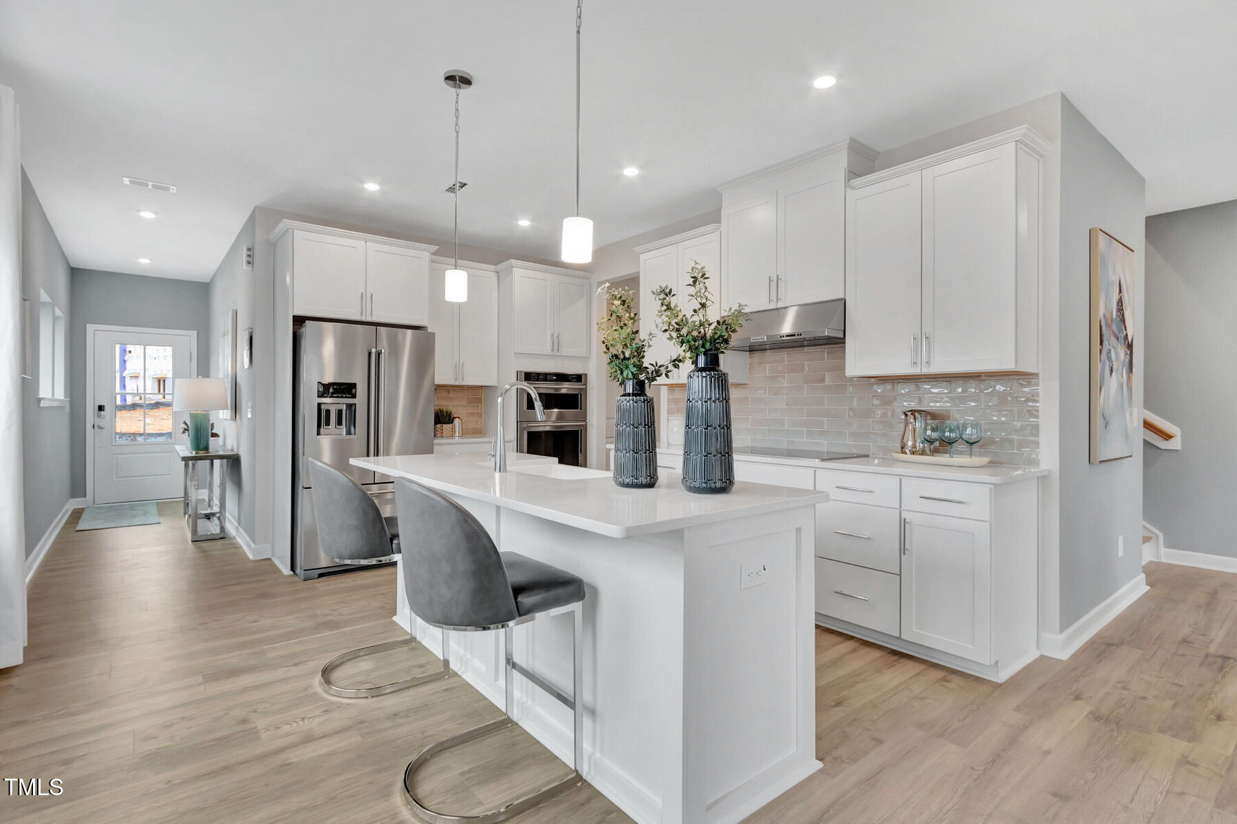 7128 Hubner Place, Unit 35 Cary, NC 27519 - Photo 4 of 17 a kitchen with white cabinets and stainless steel appliances