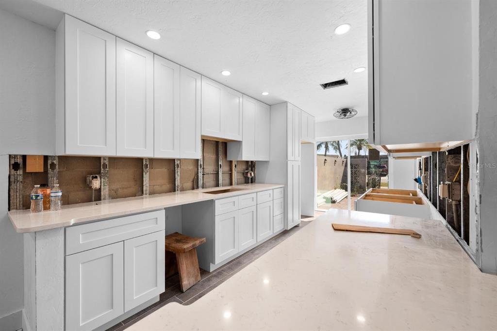 511 Boca Ciega Point Boulevard North St. Petersburg, FL 33708 - Photo 13 of 24 a large white kitchen with cabinets