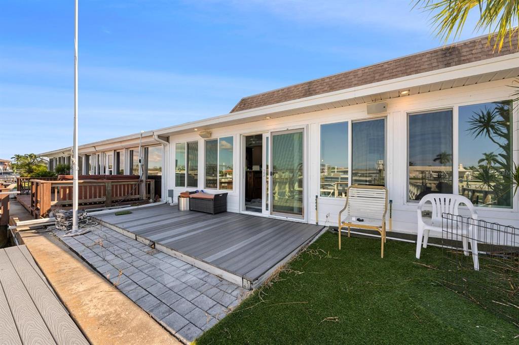 511 Boca Ciega Point Boulevard North St. Petersburg, FL 33708 - Photo 17 of 24 a view of a house with backyard porch and sitting area