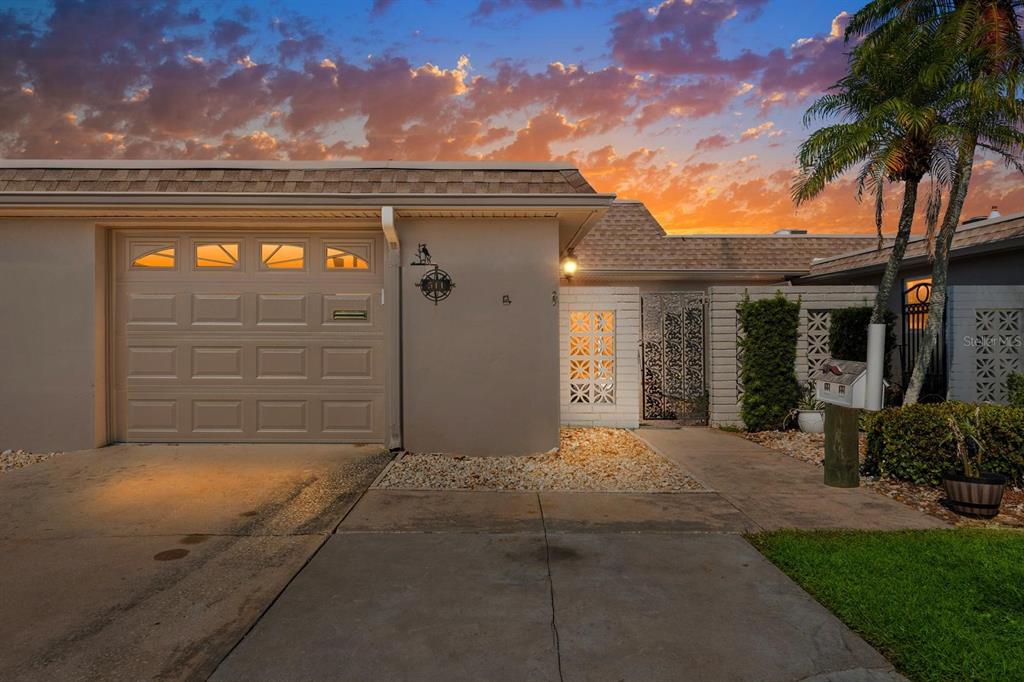 511 Boca Ciega Point Boulevard North St. Petersburg, FL 33708 - Photo 2 of 24 a front view of a house with a garden