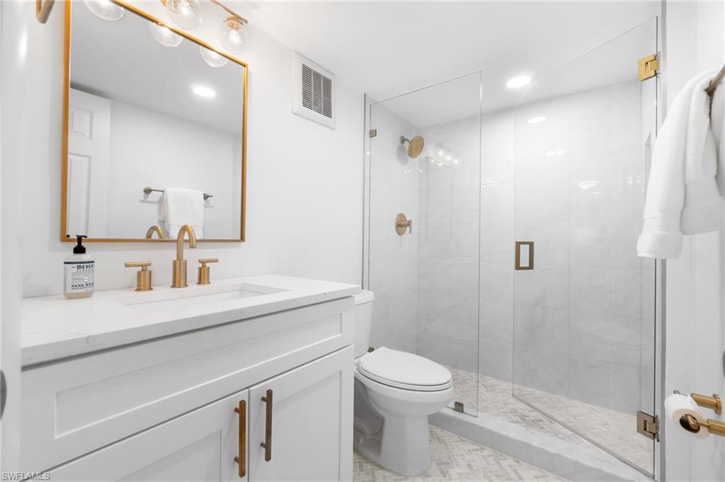 1222 Gordon Drive, Unit 2 Naples, FL 34102 - Photo 16 of 23 a bathroom with a sink a toilet and shower