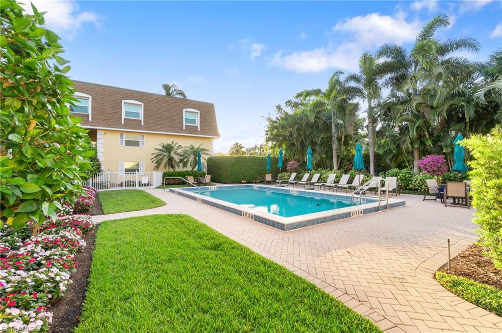 1222 Gordon Drive, Unit 2 Naples, FL 34102 - Photo 18 of 23 a view of a house with a swimming pool and sitting area