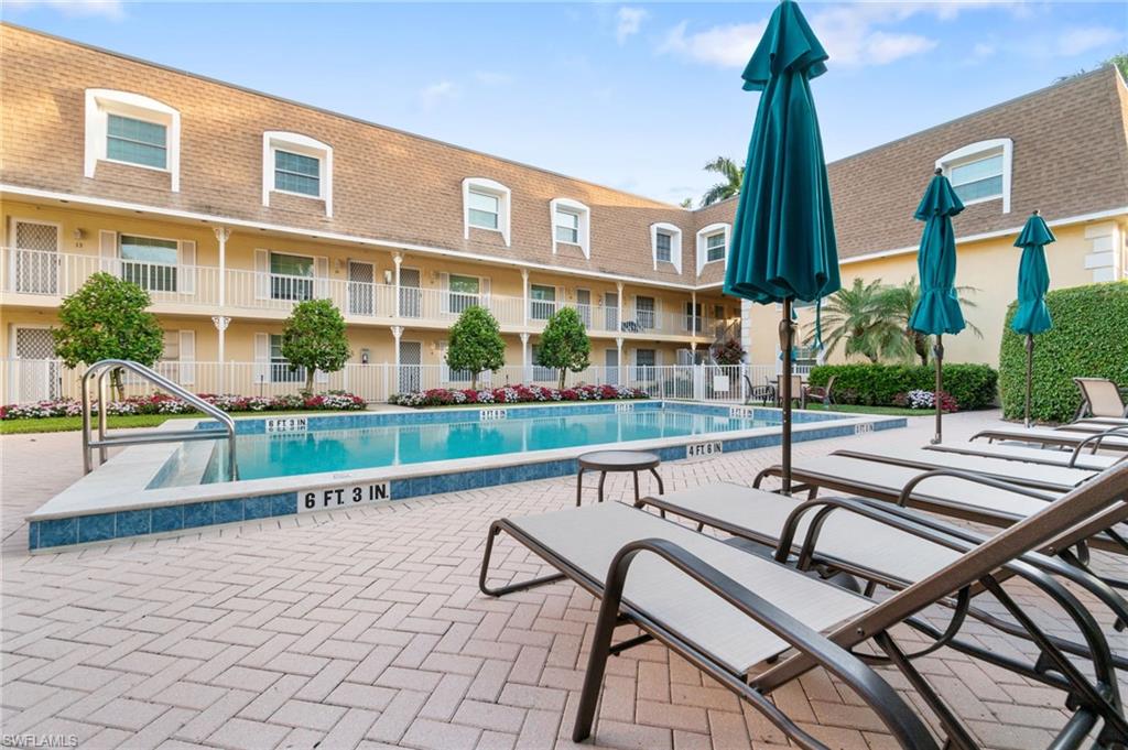 1222 Gordon Drive, Unit 2 Naples, FL 34102 - Photo 20 of 23 a view of a patio with a table and chairs