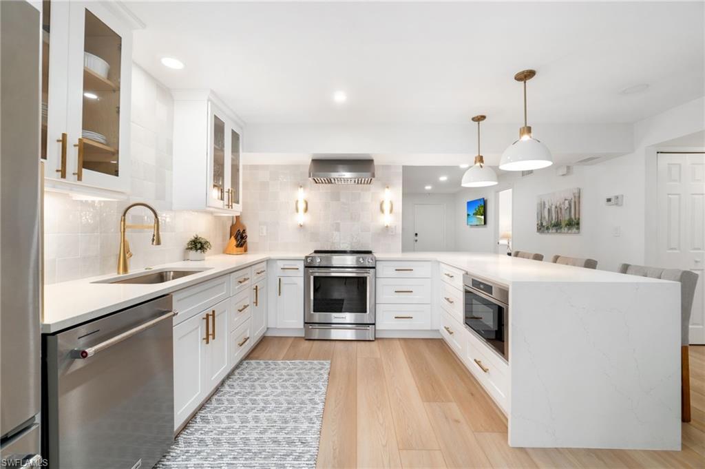 1222 Gordon Drive, Unit 2 Naples, FL 34102 - Photo 10 of 23 a kitchen with a sink stove and refrigerator