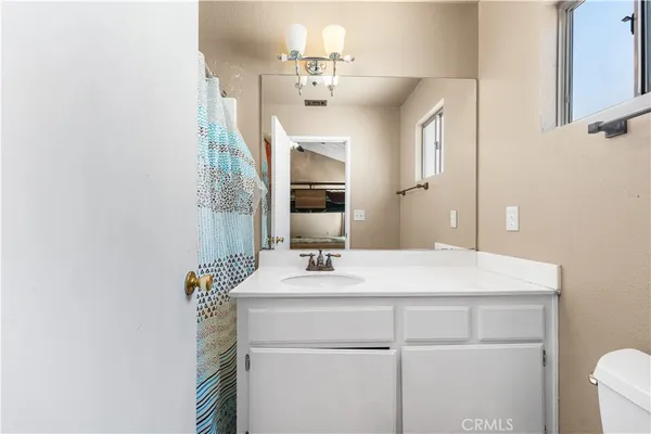 a bathroom with a sink vanity and a mirror