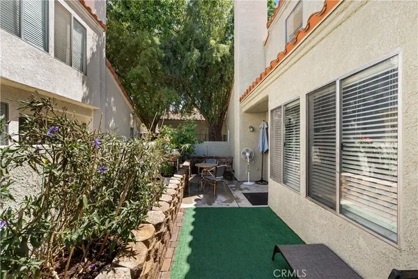 a view of backyard of house with outdoor seating